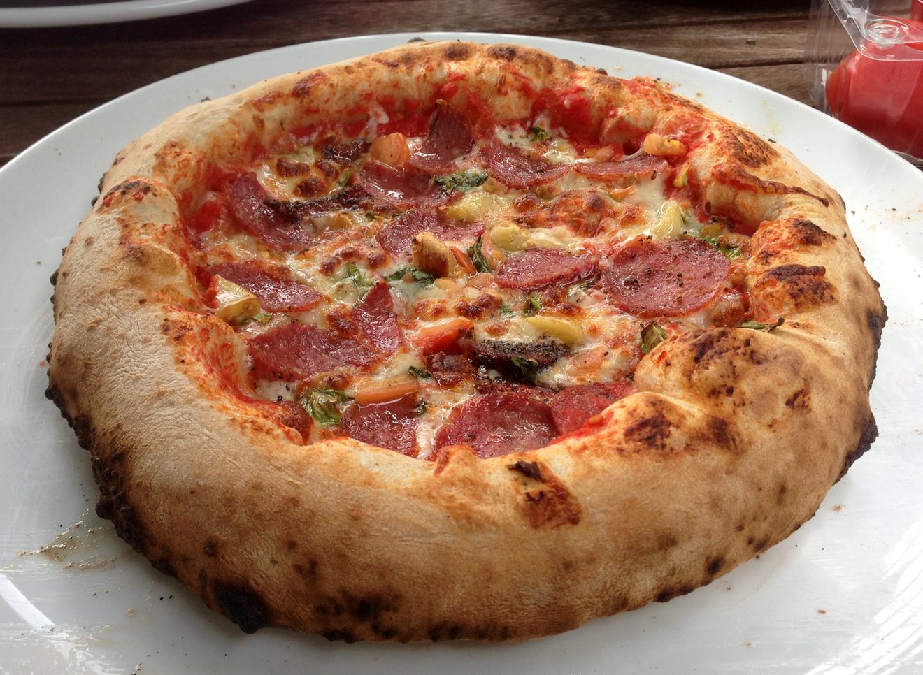 Top of the same pizza. Notice how the texture on the left is different and drier looking than the right. This was because that side had a bit more flour on it when shaping. The More You Know™